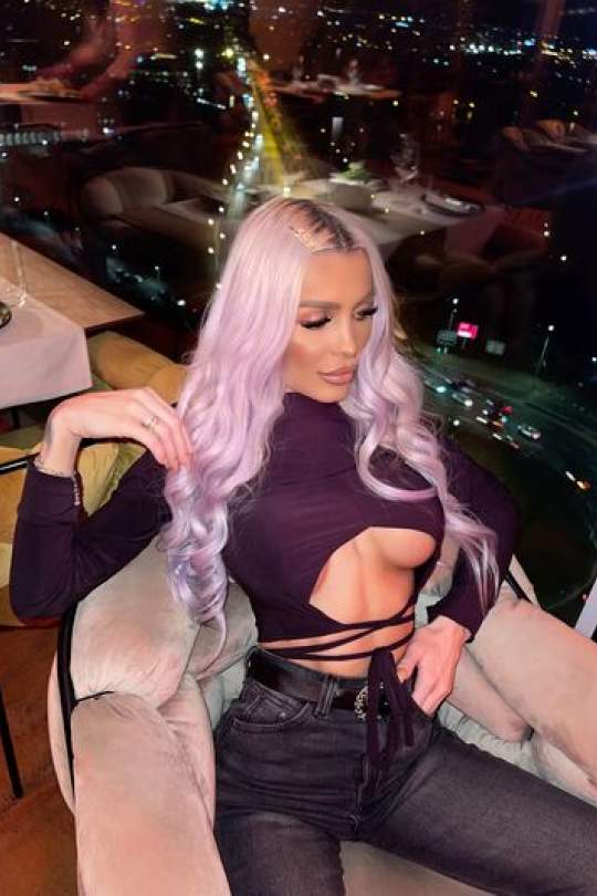 Cindy sat with a lavish background as she is showing off her platinum hair and great outfit. 